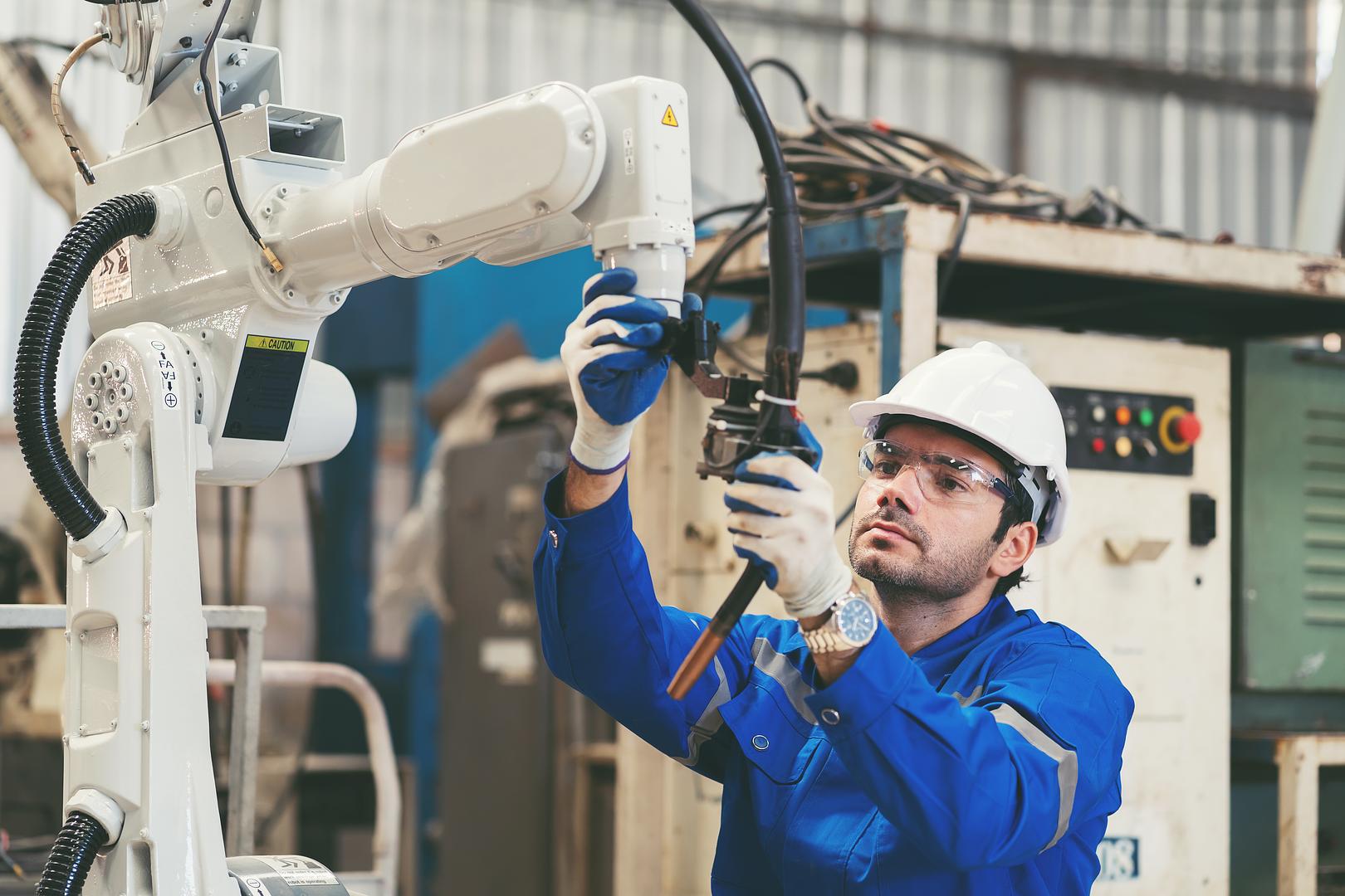 GTS inspector verifying used industrial equipment on a seller's factory floor