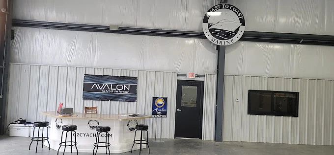 Coast to Coast Marine showroom counter with Avalon pontoon signage