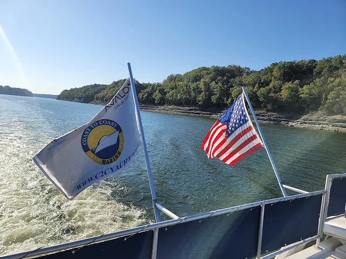 Coast to Coast Marine and American flags flying off the back of a boat on Lake Cumberland