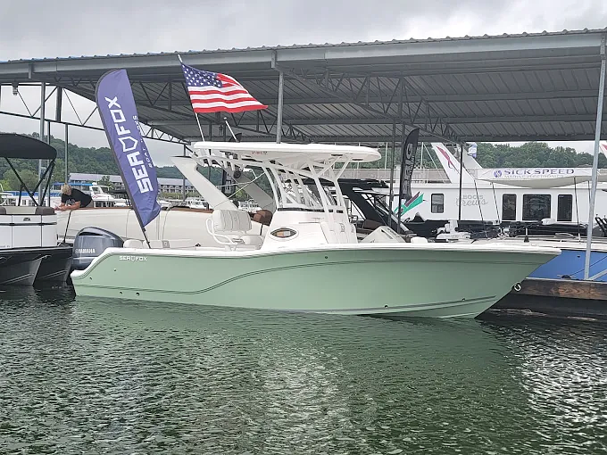 A Sea Fox center console docked under a covered slip
