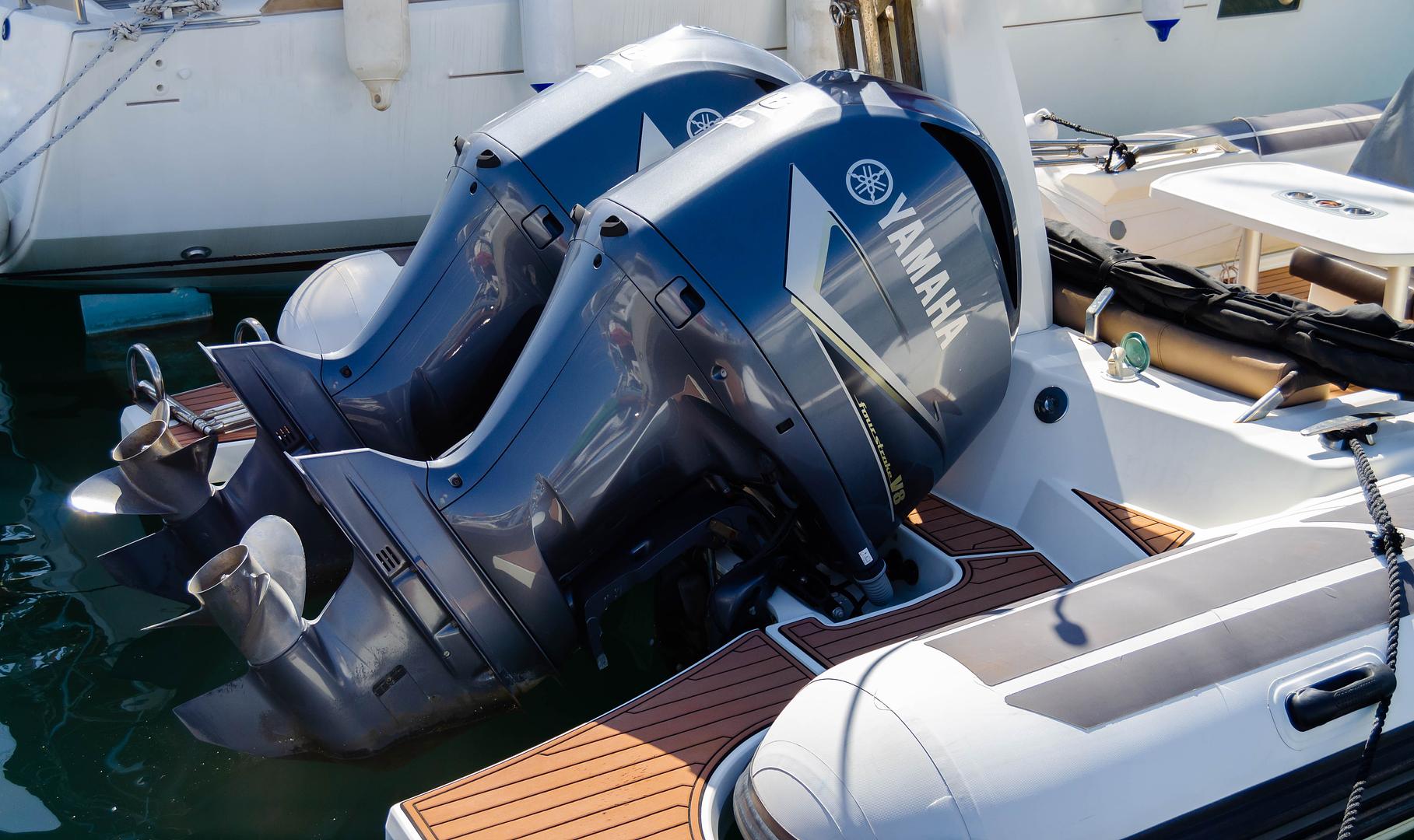 Technician servicing an outboard engine on a boat at Xtreme Outdoors Boat and RV