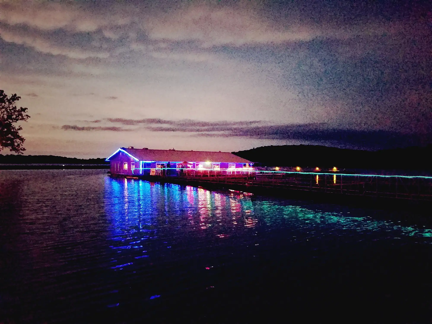 No Wake Oasis restaurant lit up at night on Stockton Lake