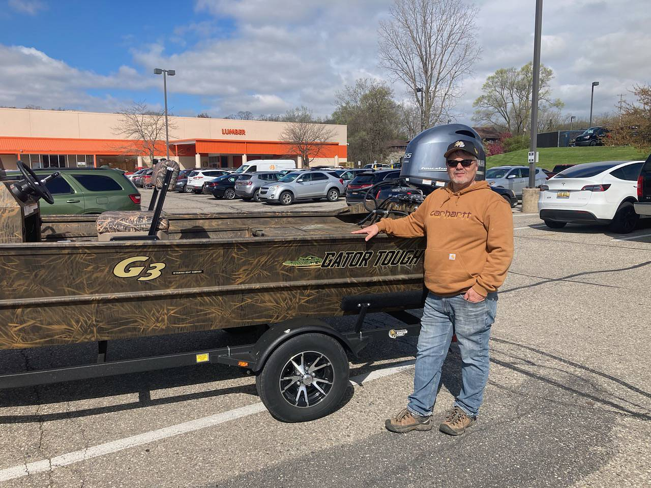 A customer standing next to his new G3 boat on a trailer