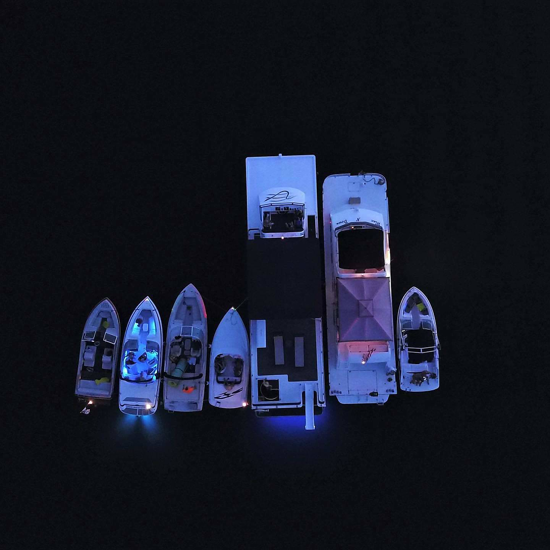 Small illuminated boat models on display in the showroom