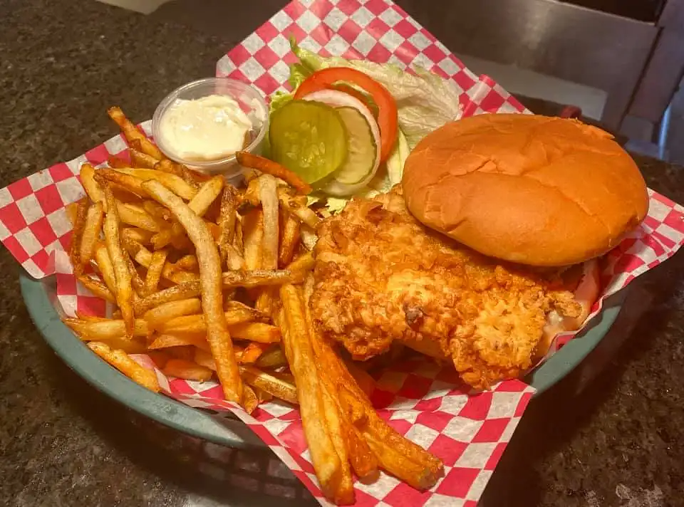 Fried food basket with fries, chicken, and a burger