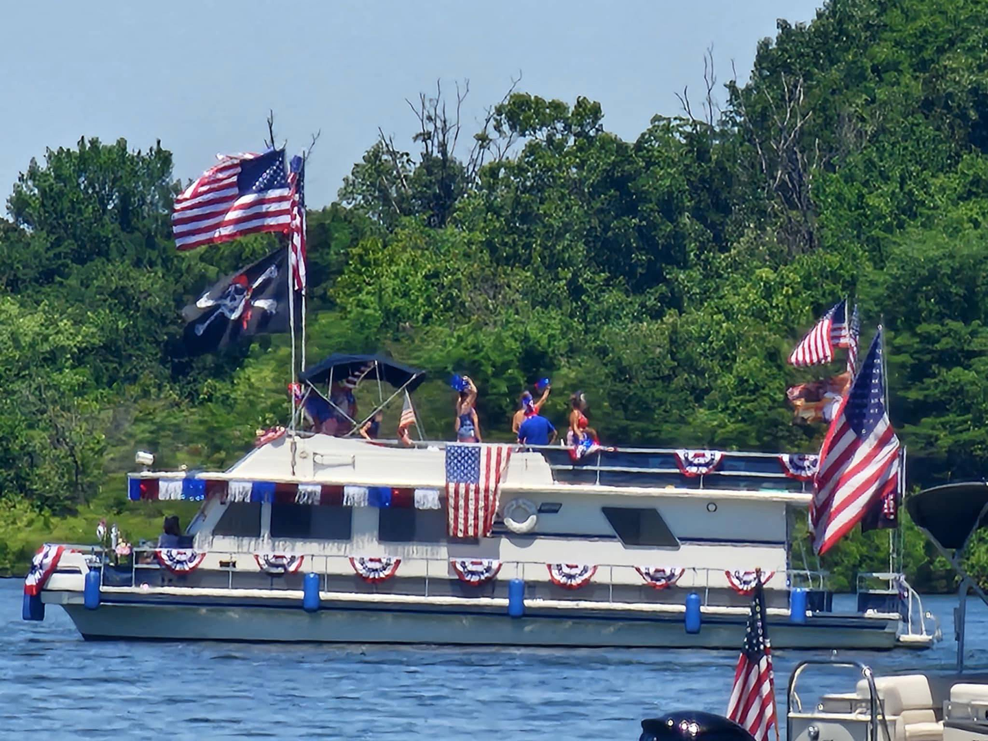 A boat decorated with American flags on the water