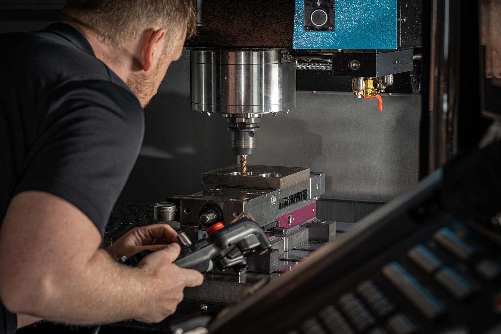 Machinist setting up a part on a milling machine