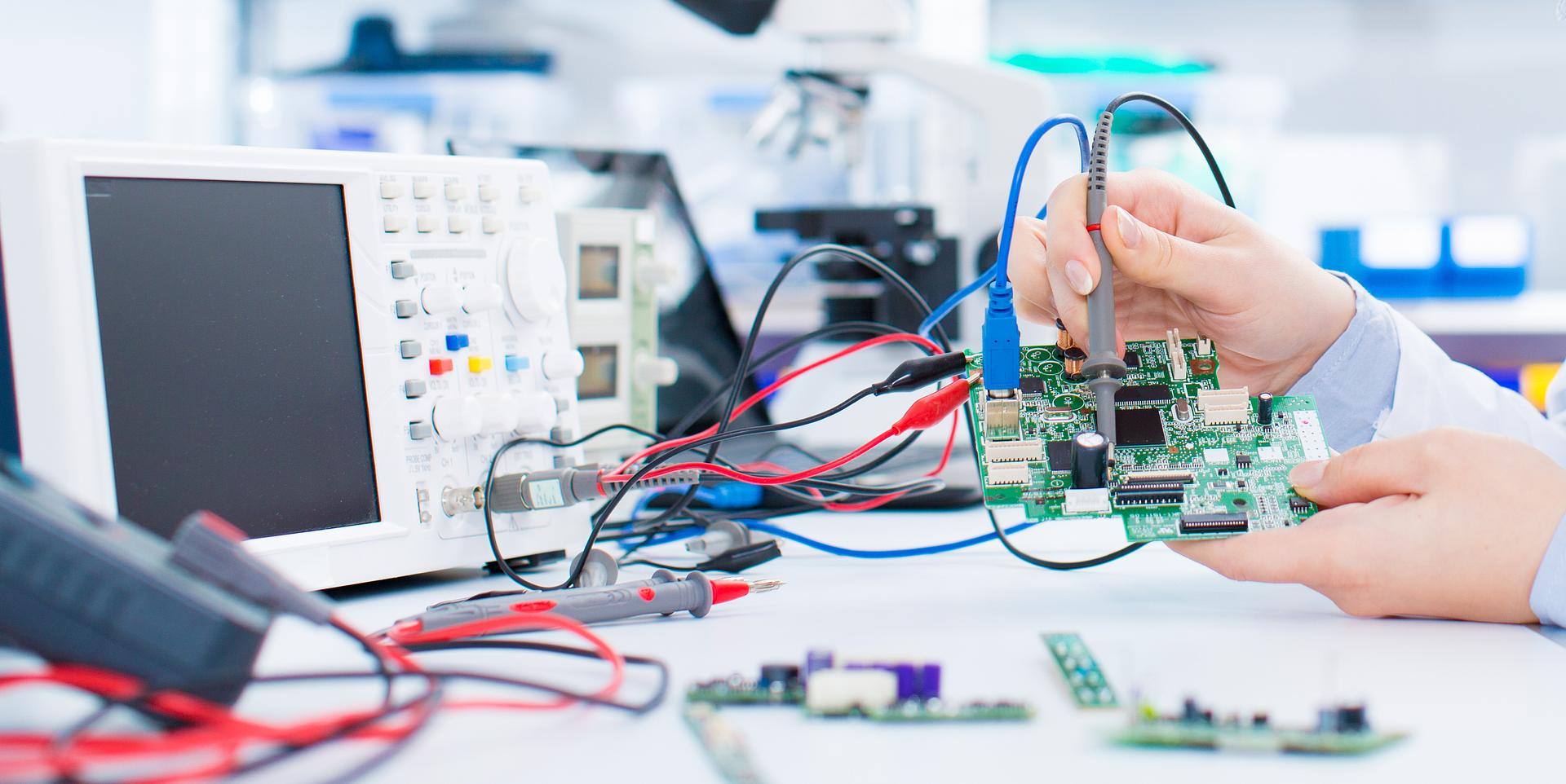 Technician testing an electronic circuit board