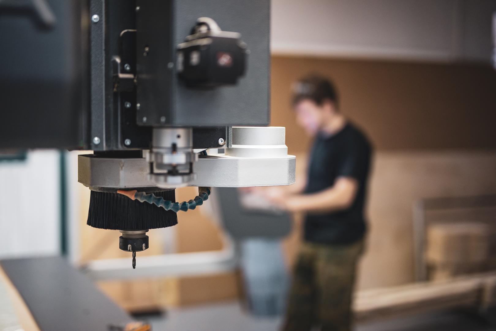 Technician performing maintenance on a machine
