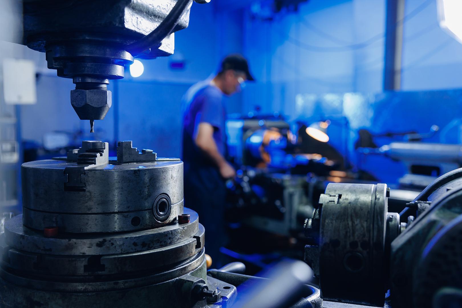 Machinist working at a lathe in a machine shop