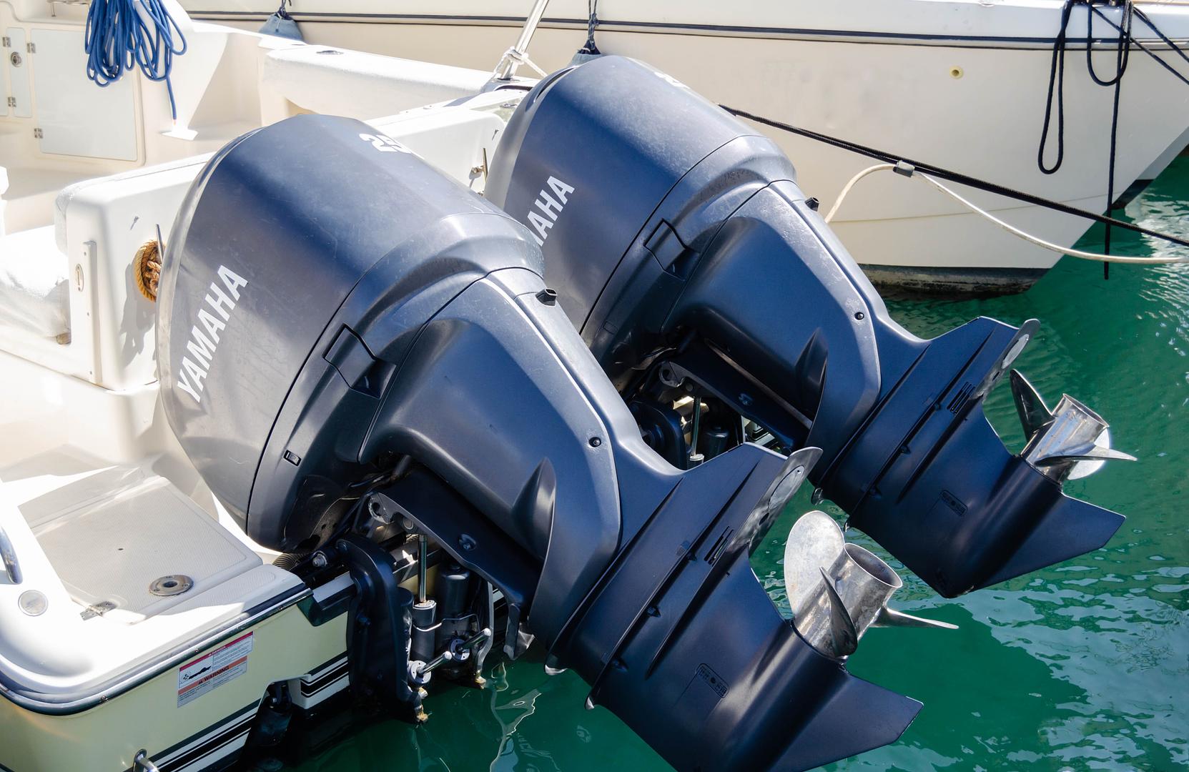 Technician inspecting a new outboard engine during a 20 hour check