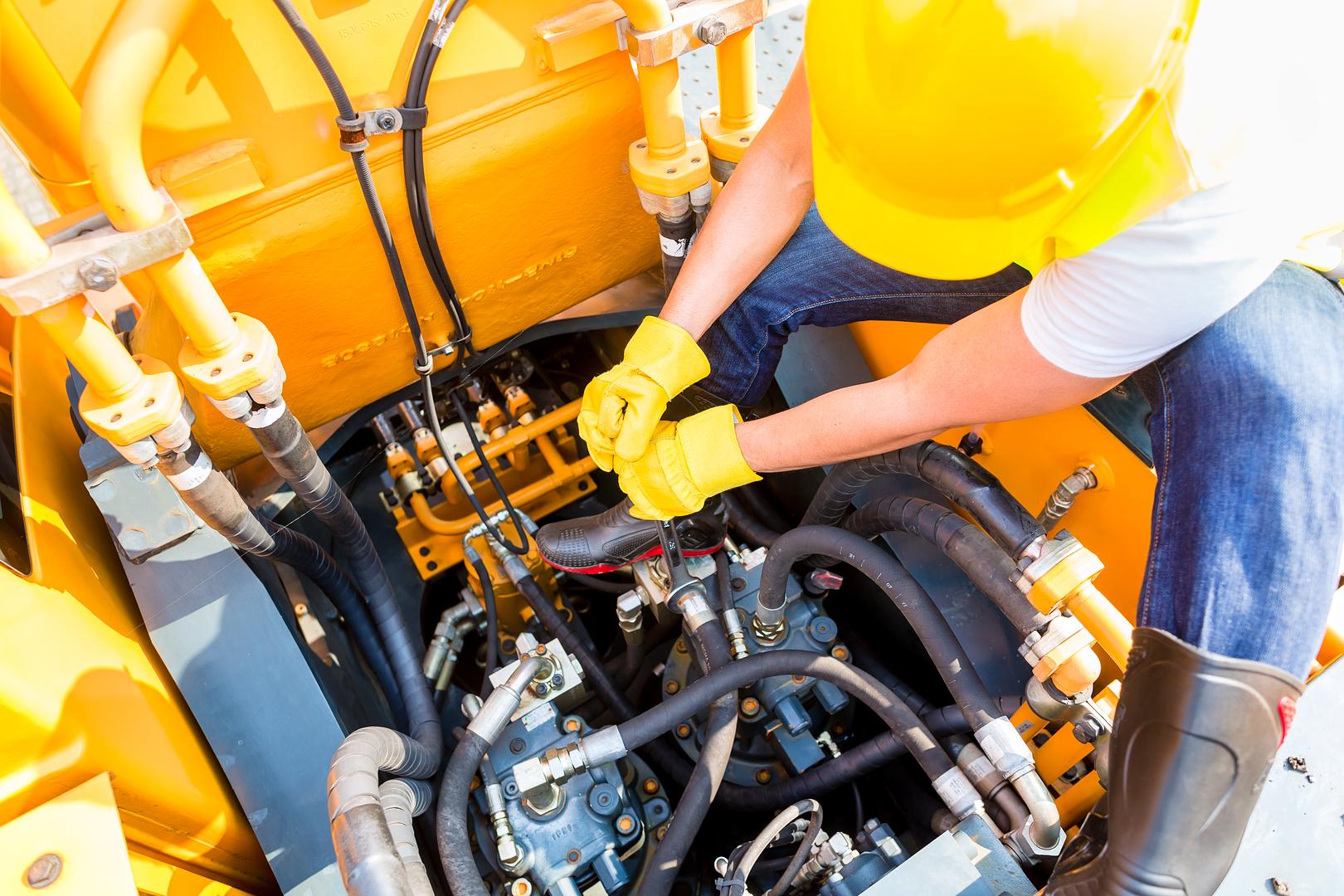 Technician performing scheduled maintenance on equipment