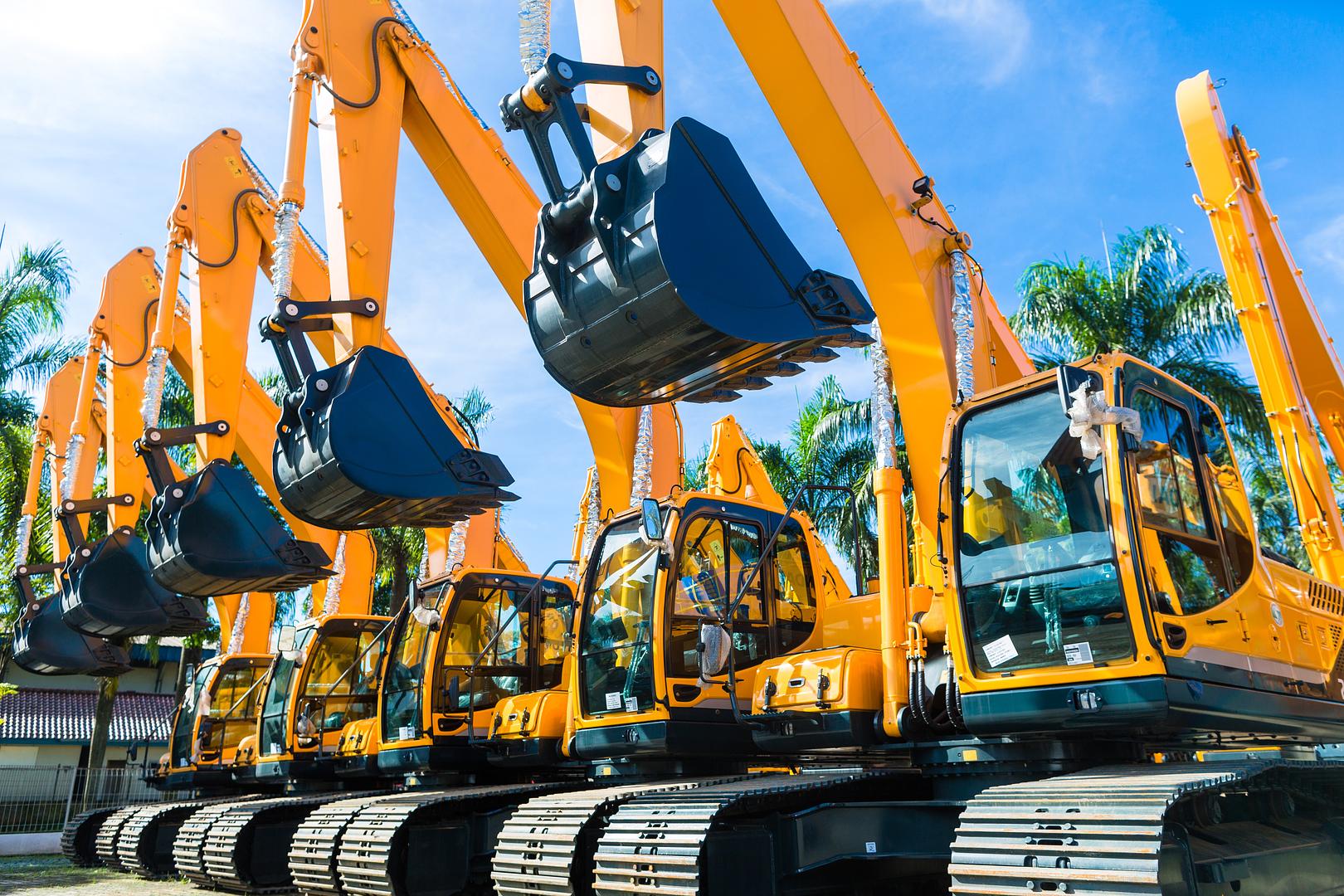Fleet of ag and construction equipment lined up at a jobsite