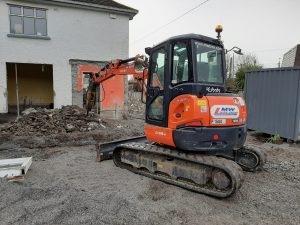 5 Tonne Digger And Rock Breaker At Work On A House Extension
