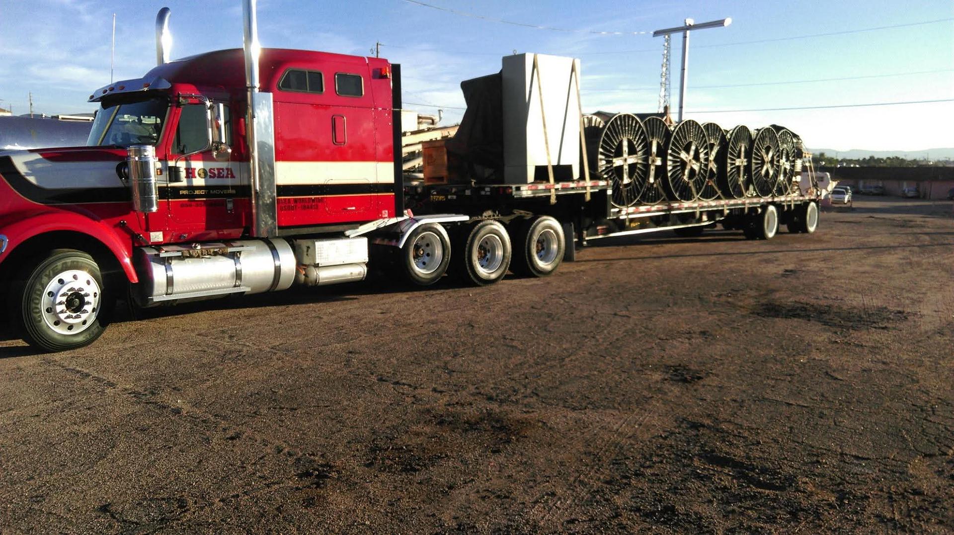 Hosea Project Movers truck hauling heavy machinery