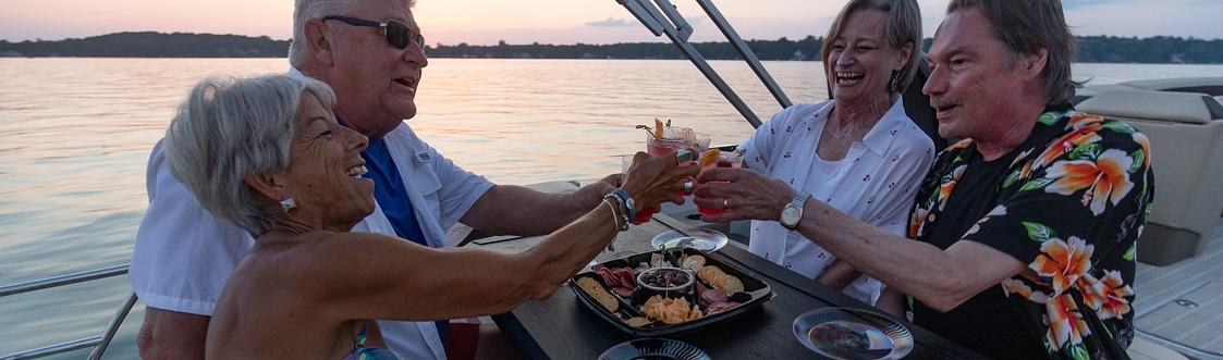Guests enjoying a pontoon rental at sunset