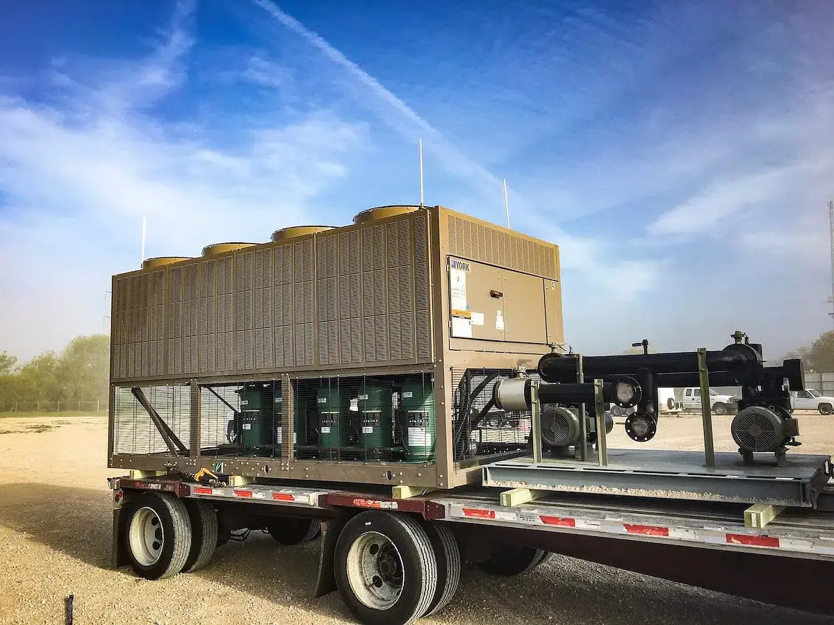 Crane lifting a chiller onto a trailer