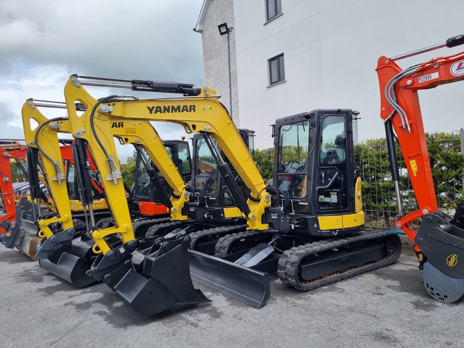 Line of Yanmar and Kubota Excavators waiting at the loading ramp for Export 