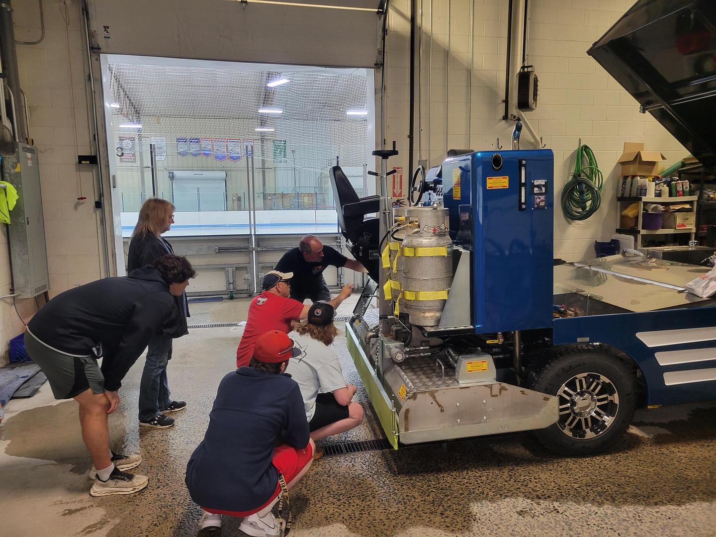 Olympia ice resurfacer on-ice — conditioner and water systems producing quality ice surface