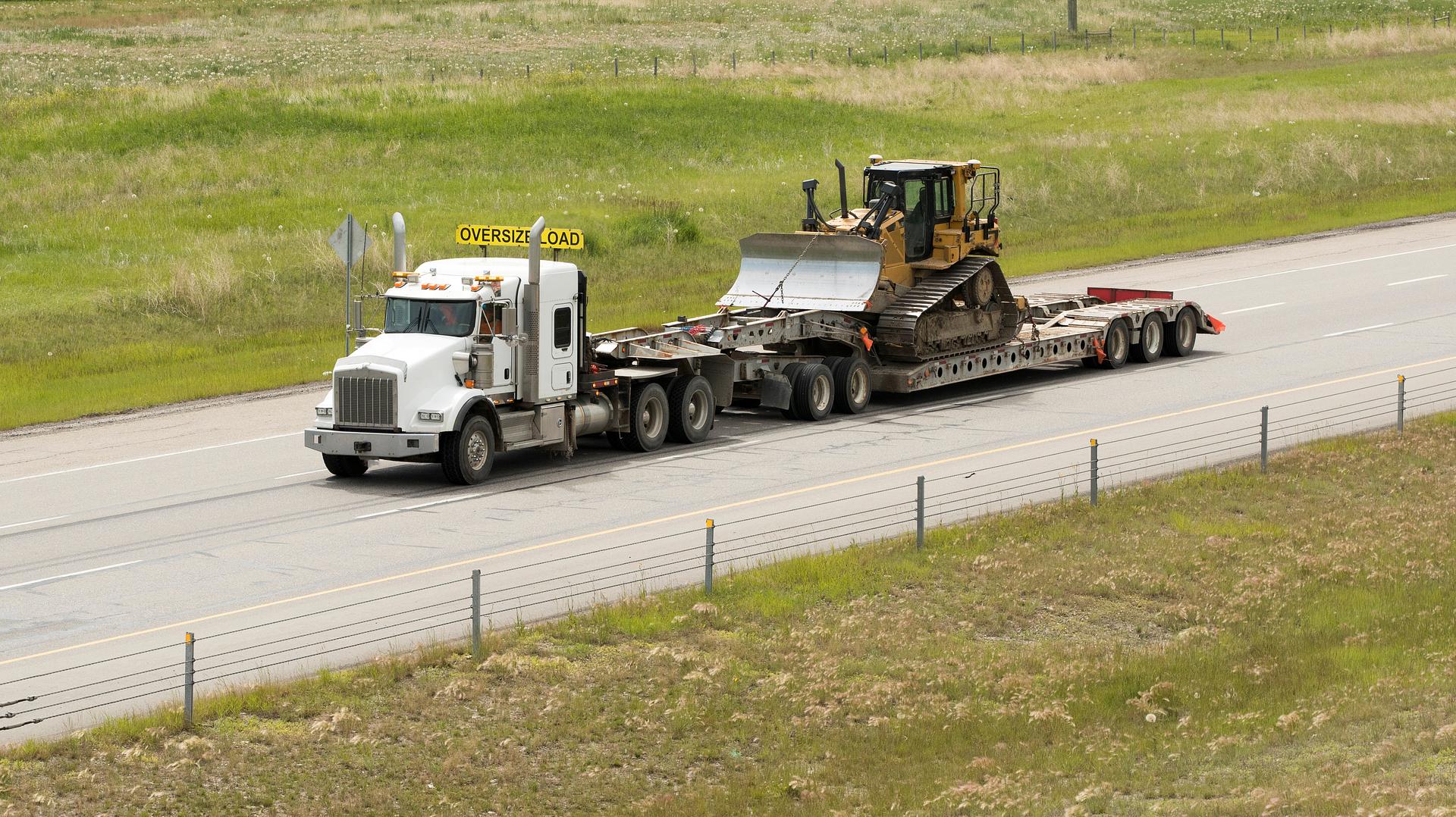 Heavy equipment loaded on a transport trailer
