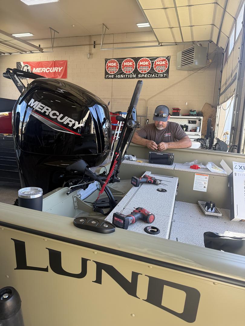 Roger working on a boat, Hurricane shop