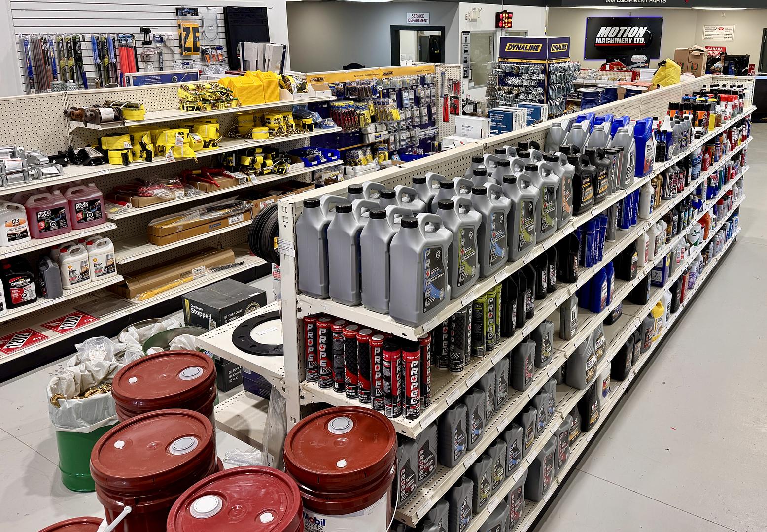 Stocked parts bins running the length of the Motion Machinery warehouse aisle