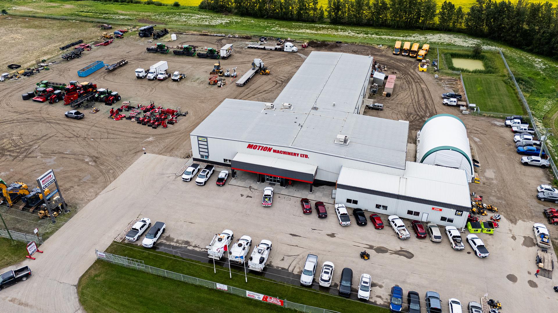 Aerial view of the Motion Machinery facility off Highway 16 with equipment lined up across the yard