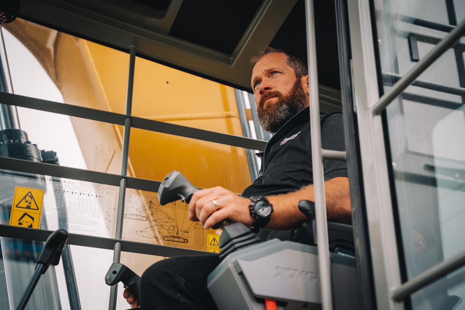 Motion Machinery team member in the cab of an XCMG excavator