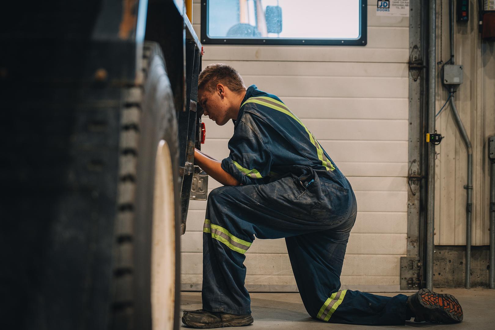 Motion Machinery technician checking a wheel on a unit in the Stony Plain shop