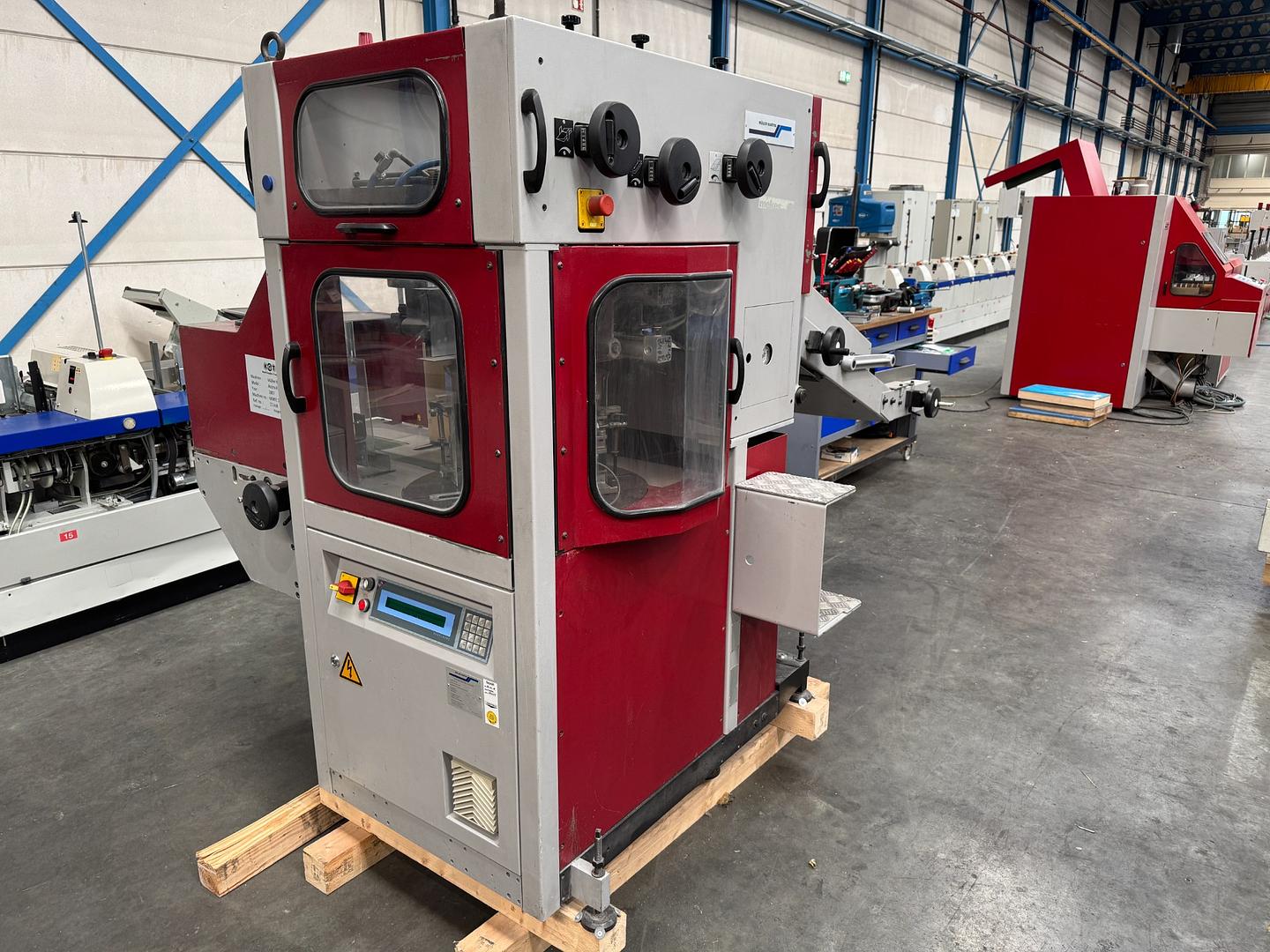 2007 - Muller Martini Acoro A7 perfect binder with inline gatherer and three knife trimmer