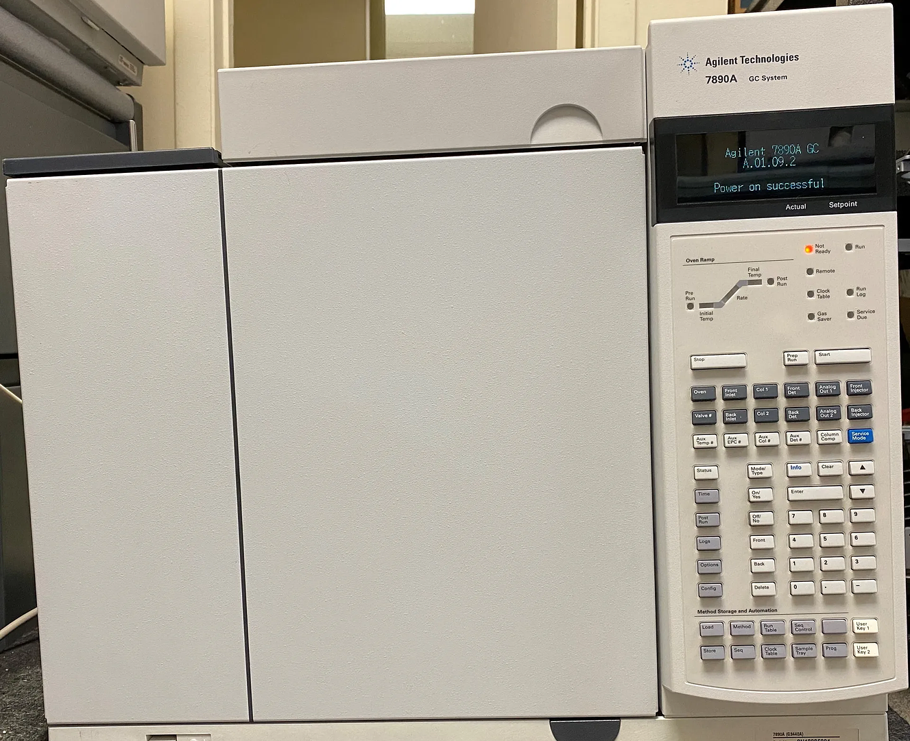 LC-GC Scientific technician diagnosing a GC autosampler system in front of the LC-GC Scientific banner