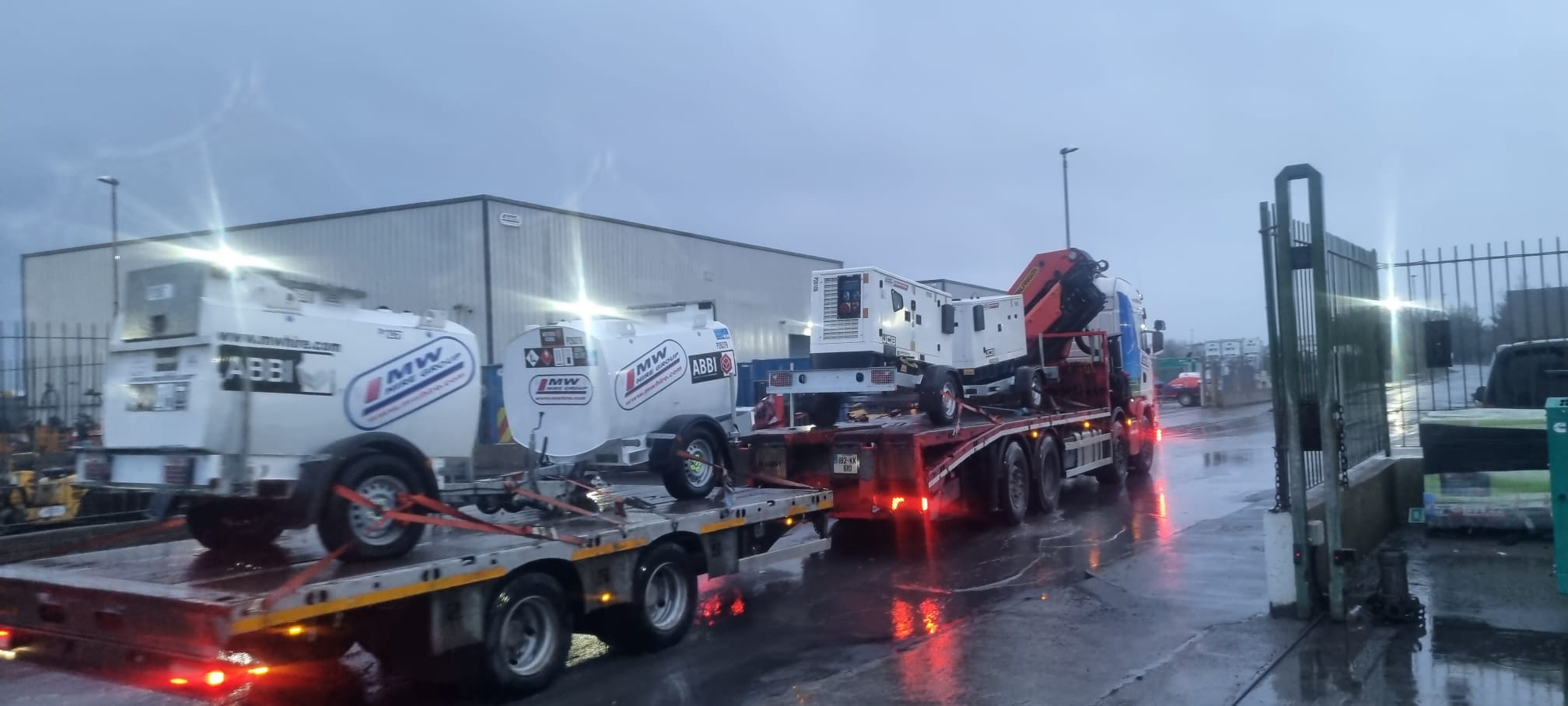 Load of Western mobile fuel tanks and road tow generators heading away to a rental project
