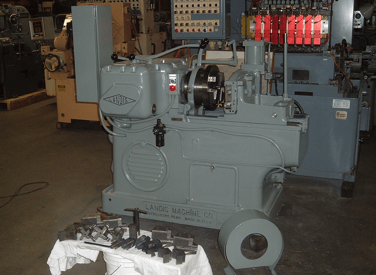 A Landis threading machine with tooling laid out for a customer