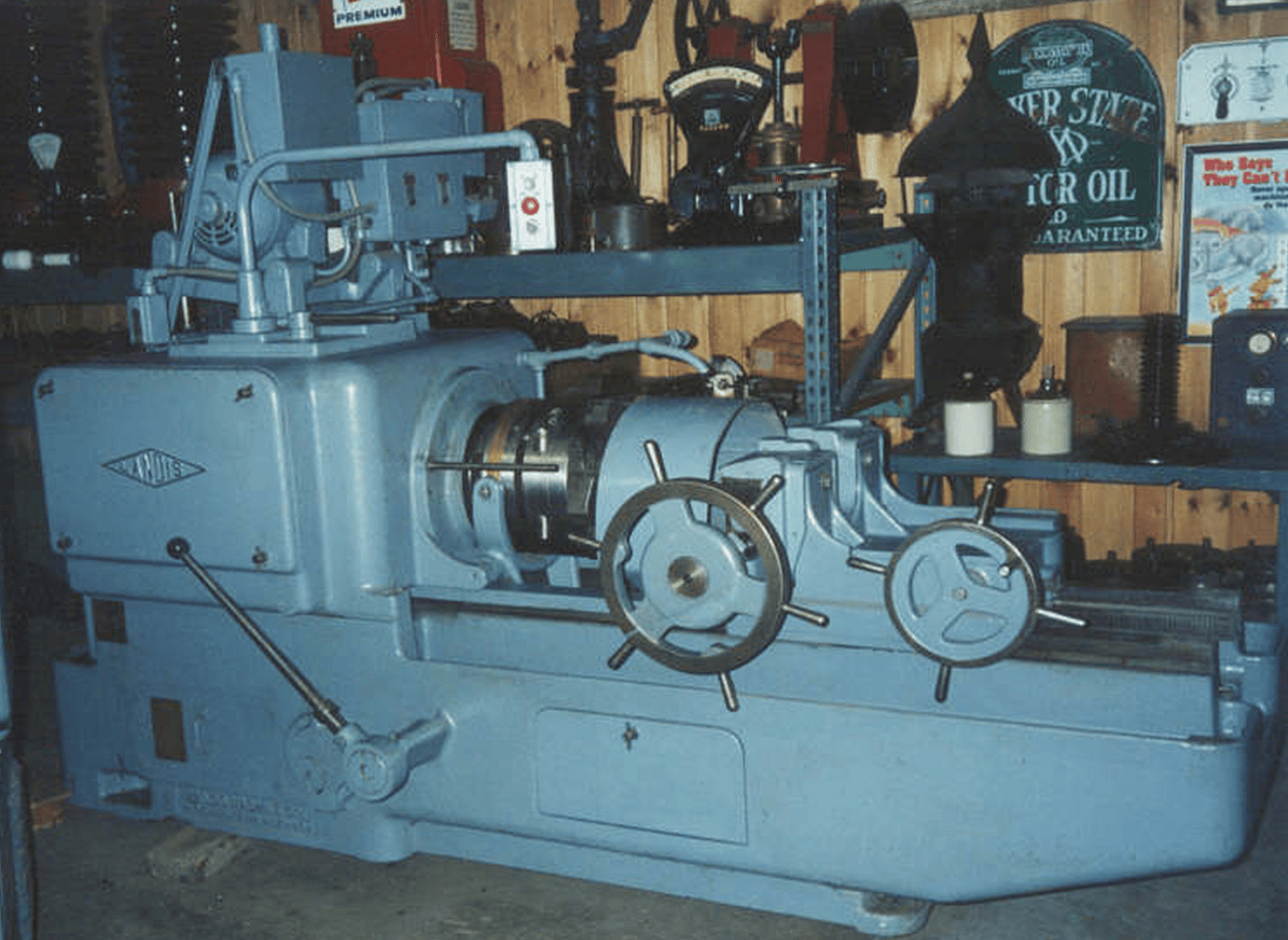 A vintage Landis machine against the wall of the Stanley Machinery shop
