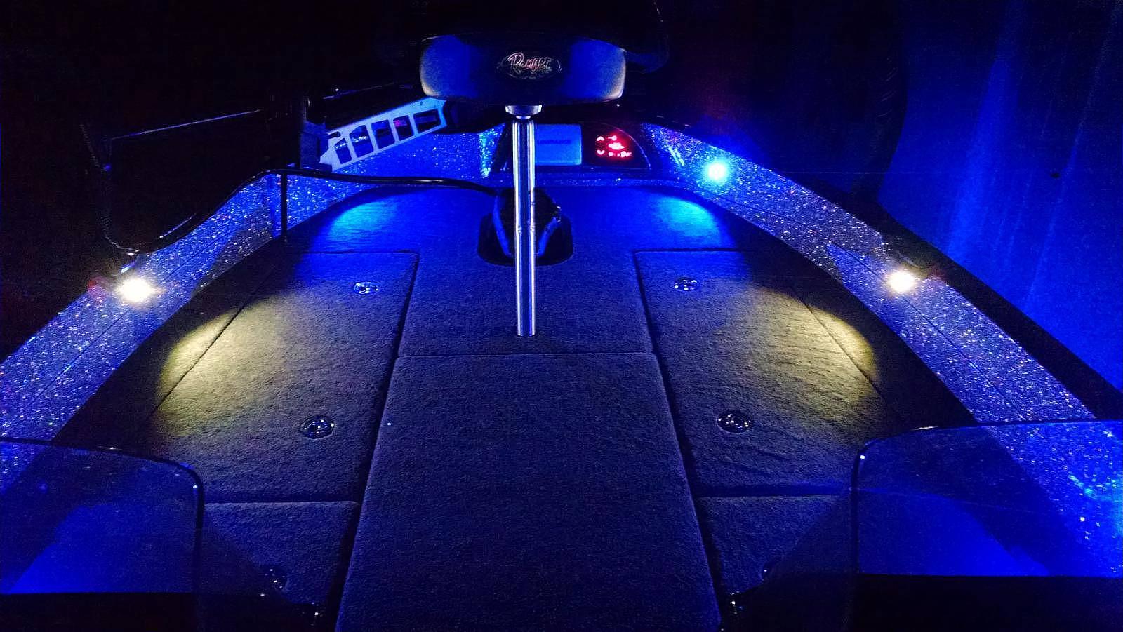 Blue LED boat lighting reflecting on water at night