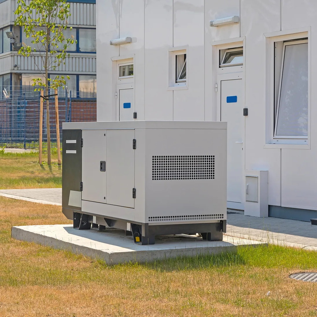 Prime power generator installed on site next to a building